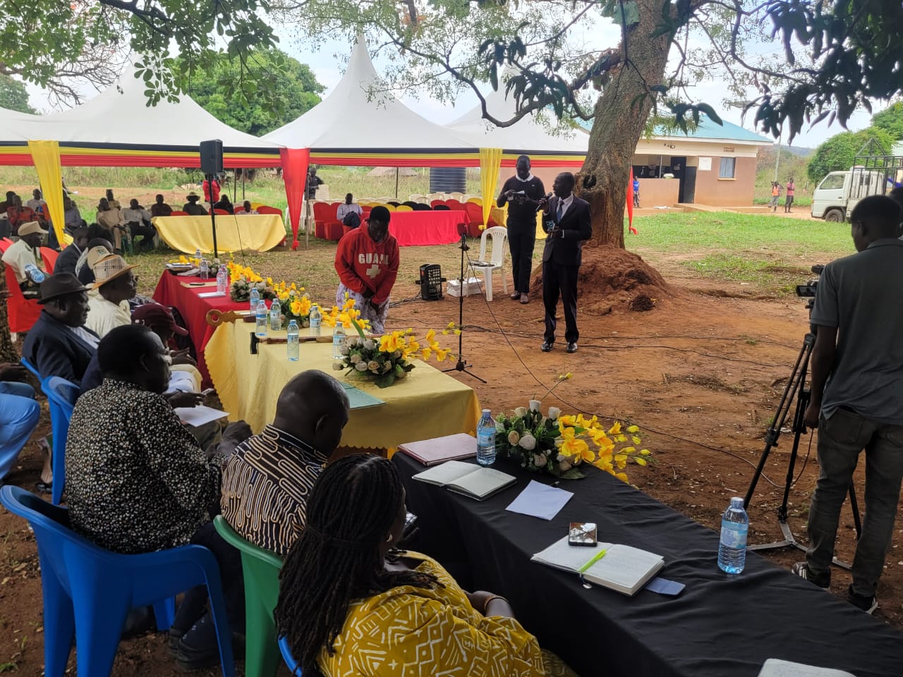 Amuru District Chief Administrative Officer addressing stakeholders during the handover of customary land certificates.